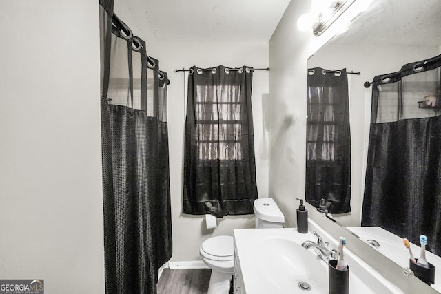 106 Vickie Dr, Warner Robins, GA 31093 - full bathroom featuring vanity, curtained shower, and wood finished floors
