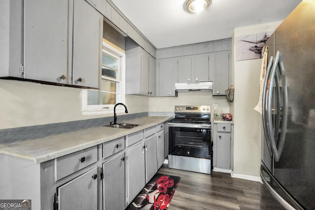 106 Vickie Dr, Warner Robins, GA 31093 - kitchen featuring stainless steel appliances, under cabinet range hood, gray cabinets, dark wood-type flooring, and light countertops