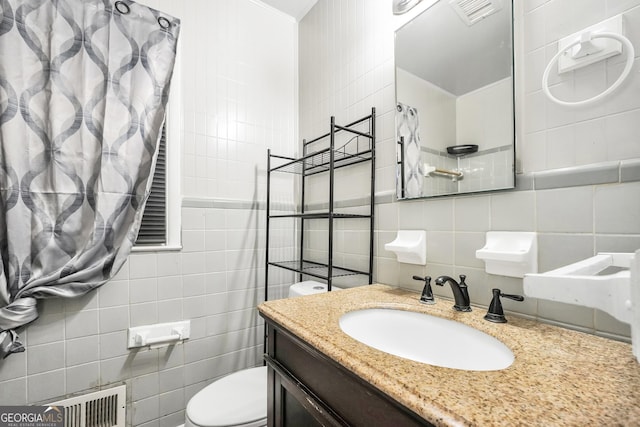 758 King Rd, Jonesboro, GA 30236 - bathroom featuring tile walls, toilet, vanity, and tasteful backsplash