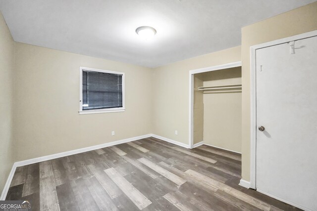 758 King Rd, Jonesboro, GA 30236 - unfurnished bedroom with wood finished floors, baseboards, and a closet