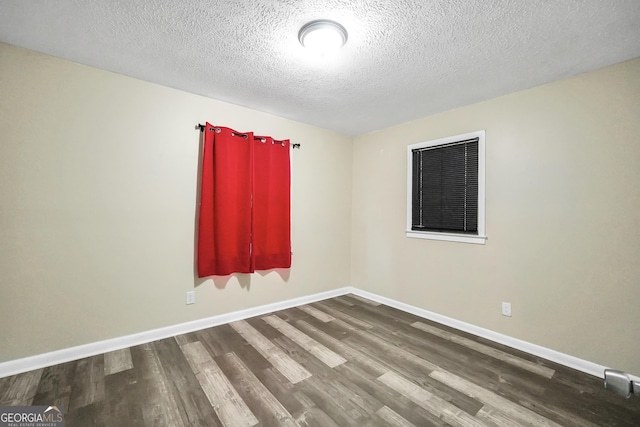 758 King Rd, Jonesboro, GA 30236 - empty room with wood finished floors, a textured ceiling, and baseboards