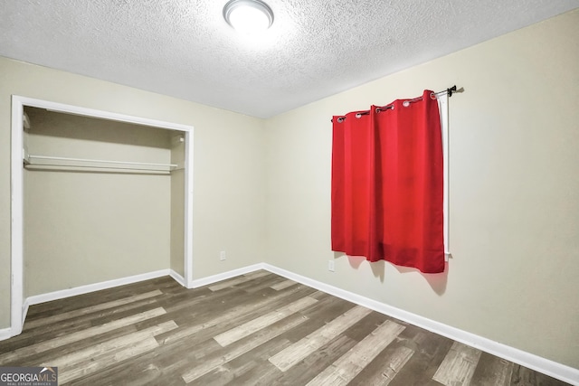 758 King Rd, Jonesboro, GA 30236 - unfurnished bedroom featuring wood finished floors, baseboards, and a textured ceiling