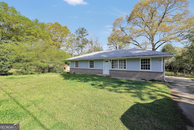 758 King Rd, Jonesboro, GA 30236 - view of front of house featuring brick siding, a front lawn, and metal roof