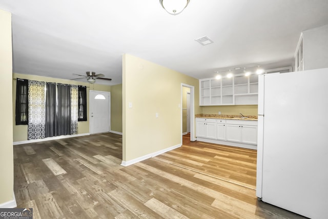 758 King Rd, Jonesboro, GA 30236 - kitchen featuring freestanding refrigerator, open shelves, white cabinets, light wood-style flooring, and a ceiling fan