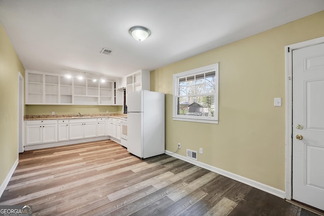 758 King Rd, Jonesboro, GA 30236 - kitchen featuring freestanding refrigerator, open shelves, range, light wood-style floors, and a sink