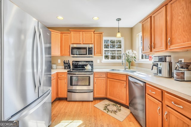 8870 Dornoch Cir, Winston, GA 30187 - kitchen with appliances with stainless steel finishes, a sink, light countertops, light wood finished floors, and recessed lighting