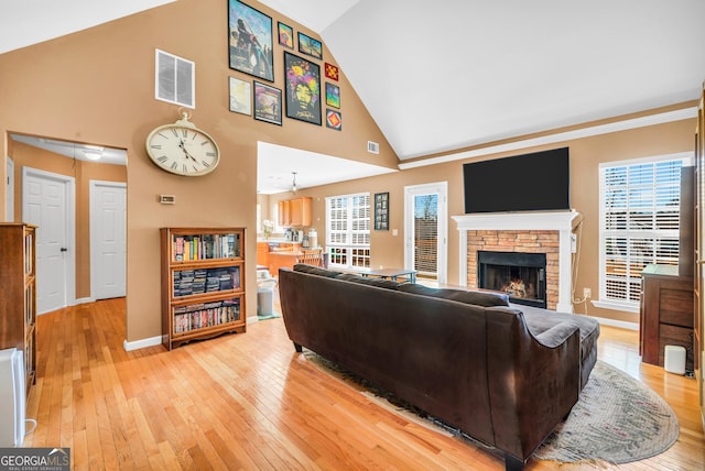 8870 Dornoch Cir, Winston, GA 30187 - living room with light wood-style floors, a fireplace, high vaulted ceiling, and baseboards