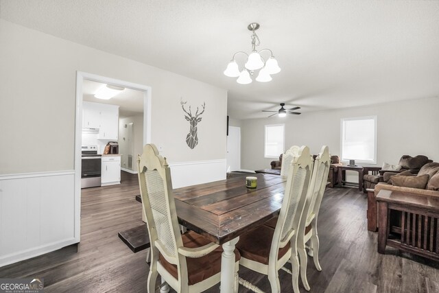 933 Chisholm Trl, Macon, GA 31220 - dining area featuring a chandelier, ceiling fan, dark wood finished floors, and a wainscoted wall