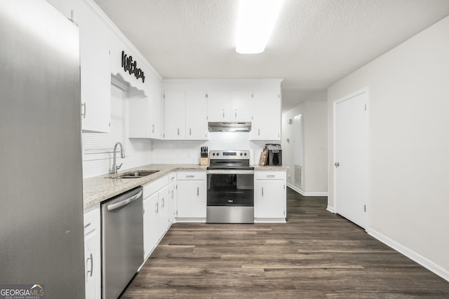 933 Chisholm Trl, Macon, GA 31220 - kitchen featuring stainless steel appliances, a sink, under cabinet range hood, a textured ceiling, and white cabinets