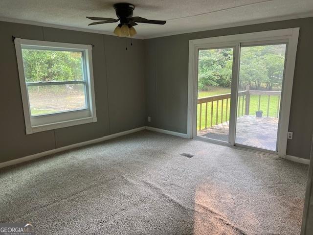 7138 Rockland Rd, Lithonia, GA 30038 - carpeted empty room with baseboards and a ceiling fan