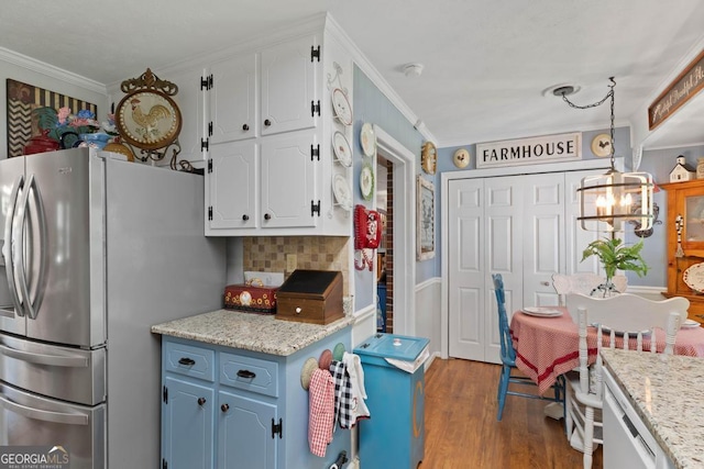 118 Duvall Dr, Stockbridge, GA 30281 - kitchen with freestanding refrigerator, backsplash, white cabinets, dark wood-style floors, and ornamental molding