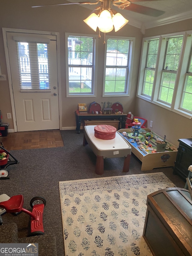 118 Duvall Dr, Stockbridge, GA 30281 - rec room with a ceiling fan, crown molding, and a wood stove