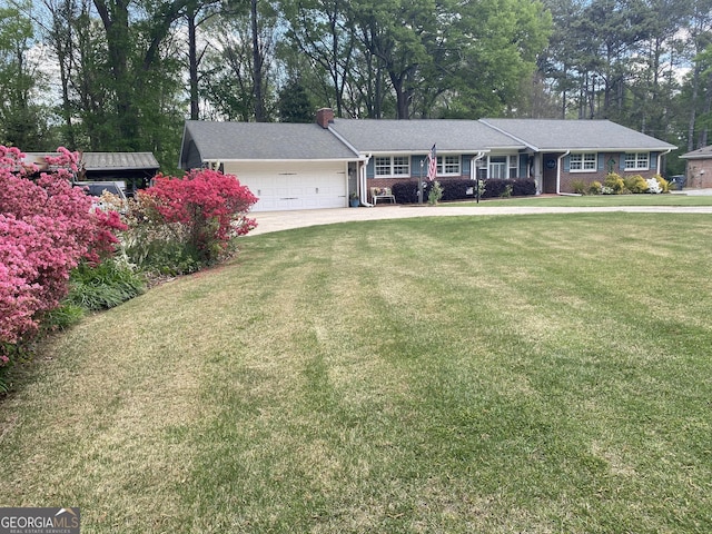 118 Duvall Dr, Stockbridge, GA 30281 - view of front of house featuring a garage, a chimney, a front yard, view of wooded area, and driveway