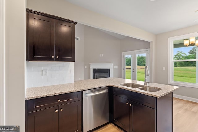 123 Oak Rd, Locust Grove, GA 30248 - kitchen with dishwasher, a sink, light wood-style flooring, light stone countertops, and dark brown cabinets