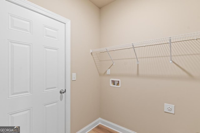 123 Oak Rd, Locust Grove, GA 30248 - washroom featuring hookup for a washing machine, baseboards, electric dryer hookup, and wood finished floors