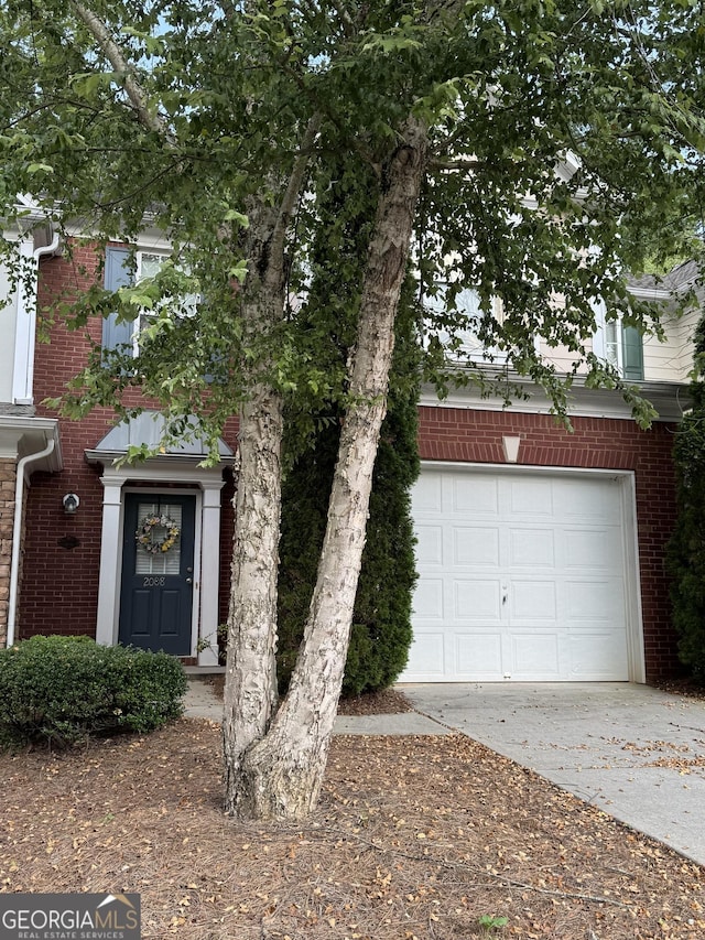 2008 Hailston Dr, Duluth, GA 30097 - obstructed view of property featuring driveway, brick siding, and a garage