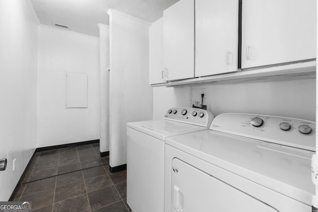 256 Battlefield Dr, Macon, GA 31217 - laundry area with washer and dryer, cabinet space, a textured ceiling, baseboards, and dark stone finish floors