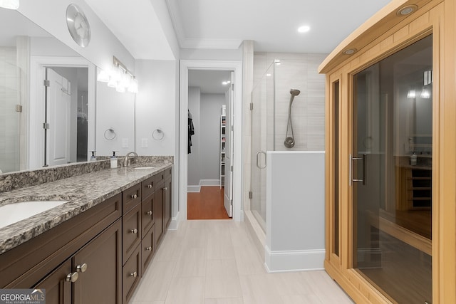 3280 Stillhouse Ln SE Unit 410, Atlanta, GA 30339 - bathroom with a spacious closet, double vanity, a stall shower, baseboards, and a sauna