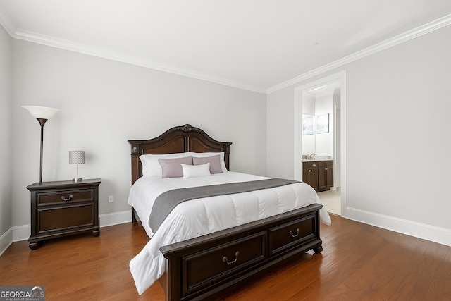 3280 Stillhouse Ln SE Unit 410, Atlanta, GA 30339 - bedroom with wood finished floors, baseboards, crown molding, and connected bathroom