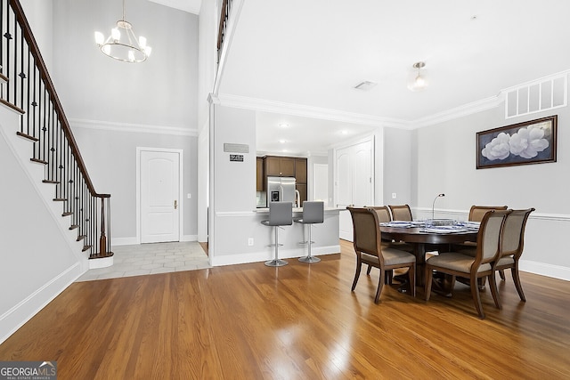 3280 Stillhouse Ln SE Unit 410, Atlanta, GA 30339 - dining area featuring stairway, a chandelier, wood finished floors, ornamental molding, and baseboards