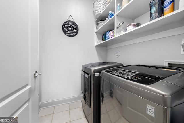 3280 Stillhouse Ln SE Unit 410, Atlanta, GA 30339 - laundry area featuring independent washer and dryer, light tile patterned floors, and baseboards