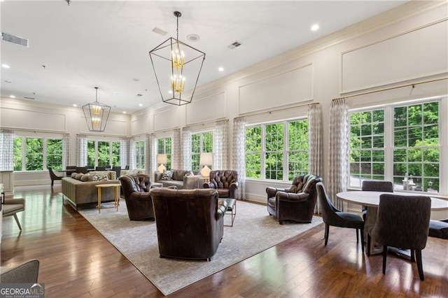 3280 Stillhouse Ln SE Unit 410, Atlanta, GA 30339 - living room with a decorative wall, a chandelier, wood-type flooring, crown molding, and recessed lighting