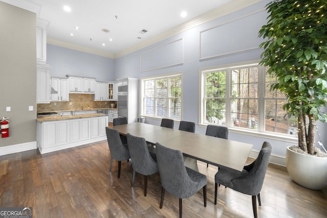 3280 Stillhouse Ln SE Unit 410, Atlanta, GA 30339 - dining room with dark wood finished floors, crown molding, baseboards, and recessed lighting