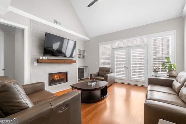 3280 Stillhouse Ln SE Unit 410, Atlanta, GA 30339 - living area with french doors, wood finished floors, a fireplace, and lofted ceiling