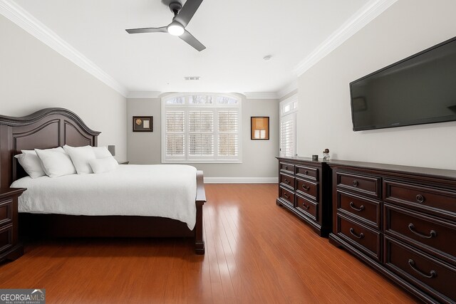 3280 Stillhouse Ln SE Unit 410, Atlanta, GA 30339 - bedroom with wood finished floors, ornamental molding, a ceiling fan, and baseboards