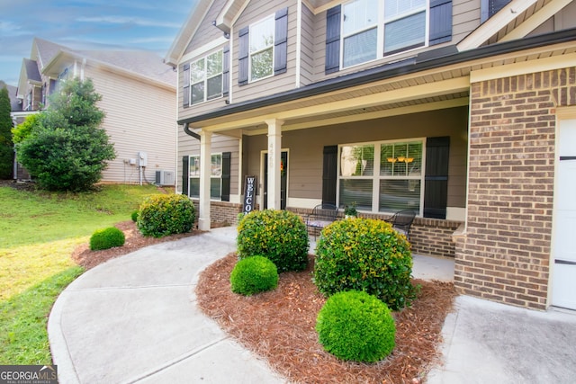 4560 Buckskin Way, Douglasville, GA 30135 - view of front of house with brick siding, covered porch, a front lawn, and cooling unit