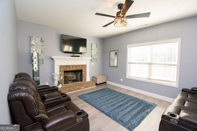 4560 Buckskin Way, Douglasville, GA 30135 - living room featuring ceiling fan, a brick fireplace, baseboards, and wood finished floors