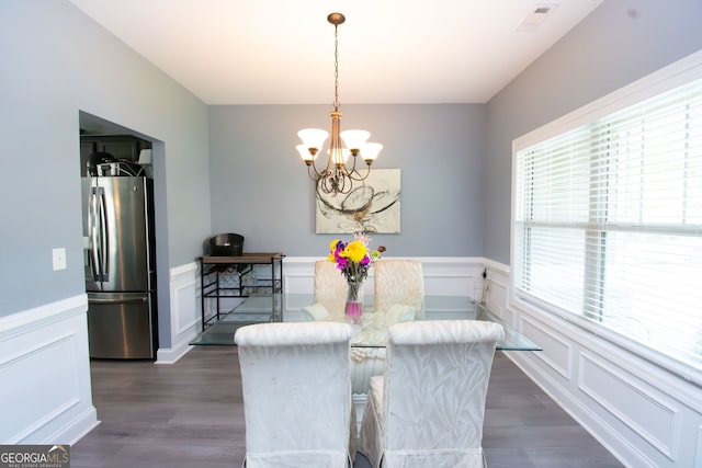 4560 Buckskin Way, Douglasville, GA 30135 - dining space featuring a chandelier, a decorative wall, a wainscoted wall, and dark wood-style floors