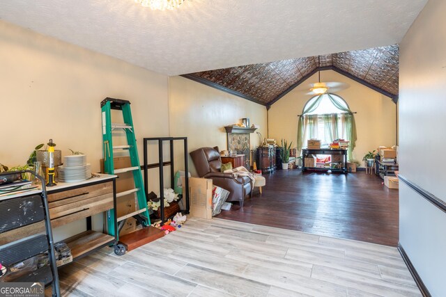 402 Stonebrooke Dr, Auburn, GA 30011 - sitting room featuring wood finished floors, lofted ceiling, and a textured ceiling