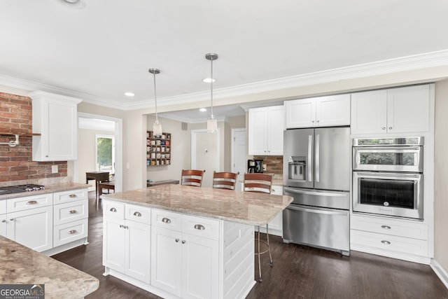 1645 Oakfield Ln, Roswell, GA 30075 - kitchen with stainless steel appliances, a breakfast bar area, white cabinets, dark wood finished floors, and backsplash