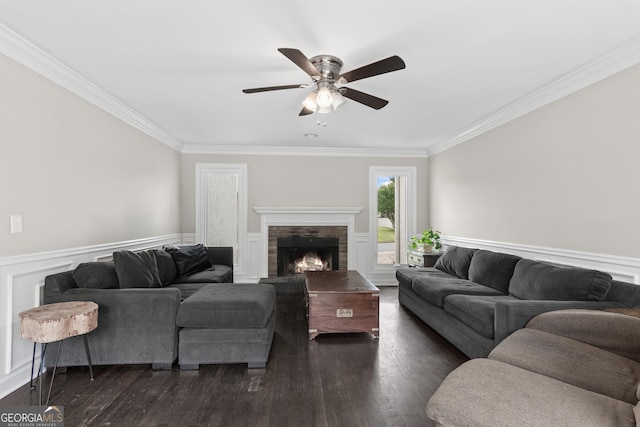 1645 Oakfield Ln, Roswell, GA 30075 - living room featuring a ceiling fan, crown molding, dark wood-type flooring, a lit fireplace, and wainscoting