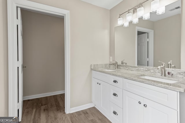 1645 Oakfield Ln, Roswell, GA 30075 - bathroom with wood finished floors, double vanity, and baseboards