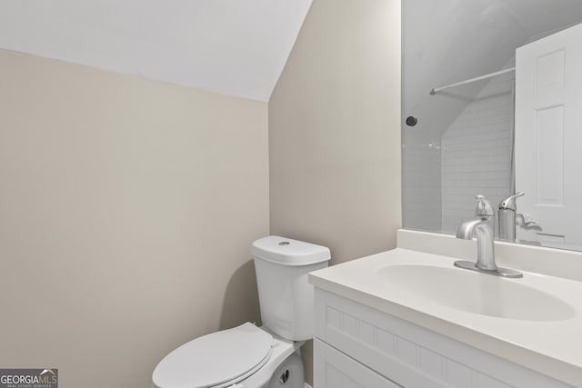 1645 Oakfield Ln, Roswell, GA 30075 - full bathroom with vaulted ceiling, vanity, and toilet