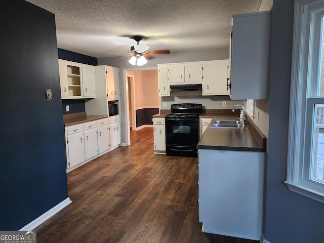 1751 Brindle Ln, Macon, GA 31220 - kitchen with black electric range oven, a sink, under cabinet range hood, dark countertops, and white cabinetry