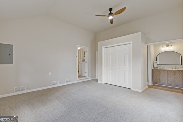 1312 Milstead Ave NE, Conyers, GA 30012 - unfurnished bedroom featuring electric panel, carpet, lofted ceiling, and ensuite bathroom