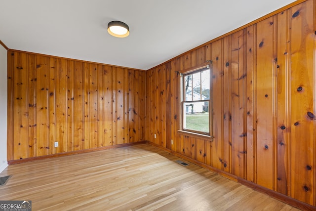 1312 Milstead Ave NE, Conyers, GA 30012 - spare room with light wood-style flooring and wooden walls