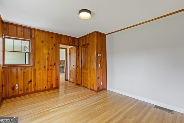 1312 Milstead Ave NE, Conyers, GA 30012 - empty room with light wood finished floors and wood walls