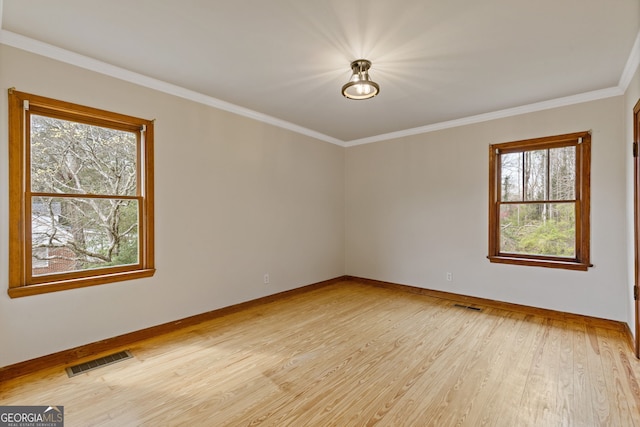 1312 Milstead Ave NE, Conyers, GA 30012 - unfurnished room with light wood-style floors, plenty of natural light, and crown molding