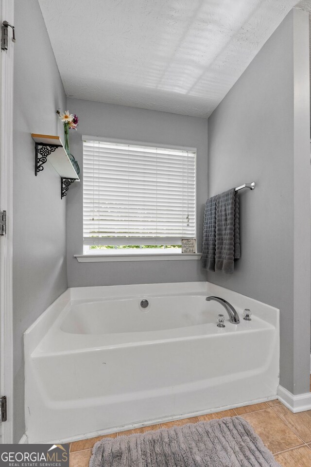 2009 Parador Aly, Mcdonough, GA 30253 - bathroom with a garden tub and tile patterned floors