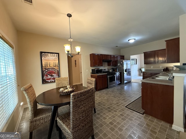 3205 Anneewakee Falls Parkway, Douglasville, GA 30135 - dining room featuring a chandelier and dark flooring