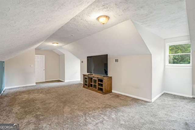 3488 Pebble Brook Ln, Stockbridge, GA 30281 - bonus room with carpet flooring, baseboards, a textured ceiling, and lofted ceiling
