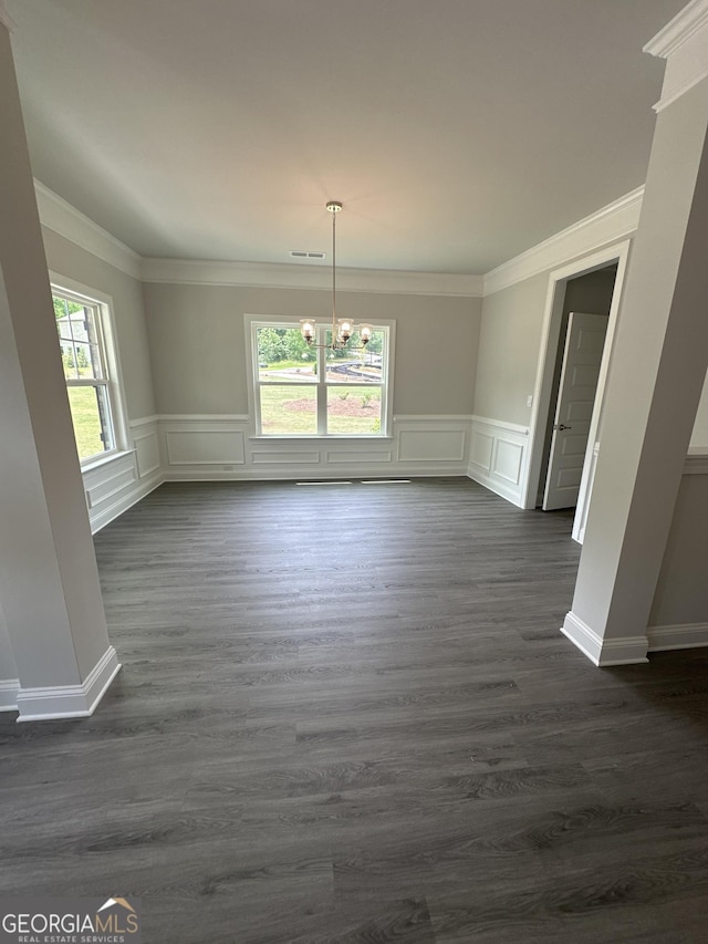 5000 Fairview Cir, Villa Rica, GA 30180 - unfurnished dining area with a chandelier, crown molding, a decorative wall, dark wood-type flooring, and wainscoting