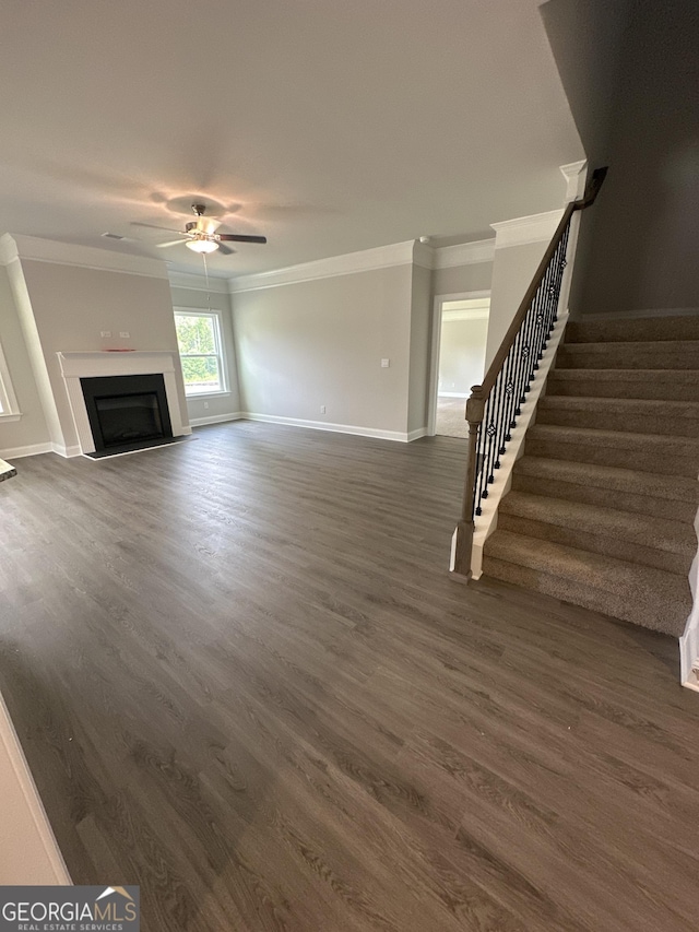 5000 Fairview Cir, Villa Rica, GA 30180 - unfurnished living room with ornamental molding, stairs, a ceiling fan, dark wood-style floors, and baseboards