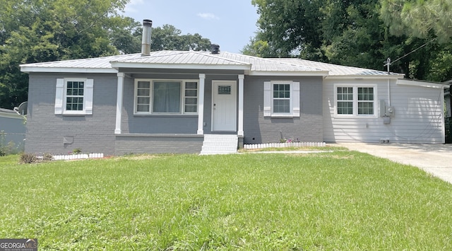 3433 Sandra Fay Dr, Macon, GA 31206 - view of front of house featuring a front lawn, metal roof, and brick siding