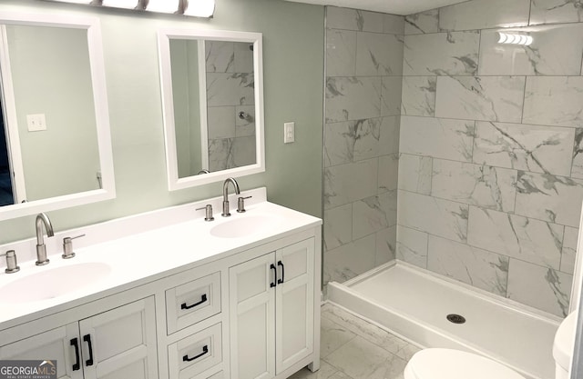 3433 Sandra Fay Dr, Macon, GA 31206 - bathroom with marble look tiles, double vanity, toilet, and a tile shower
