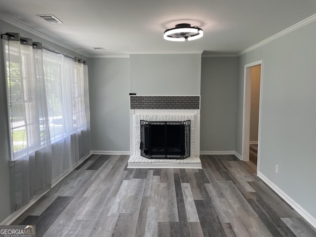3433 Sandra Fay Dr, Macon, GA 31206 - unfurnished living room featuring a brick fireplace, wood finished floors, crown molding, and baseboards